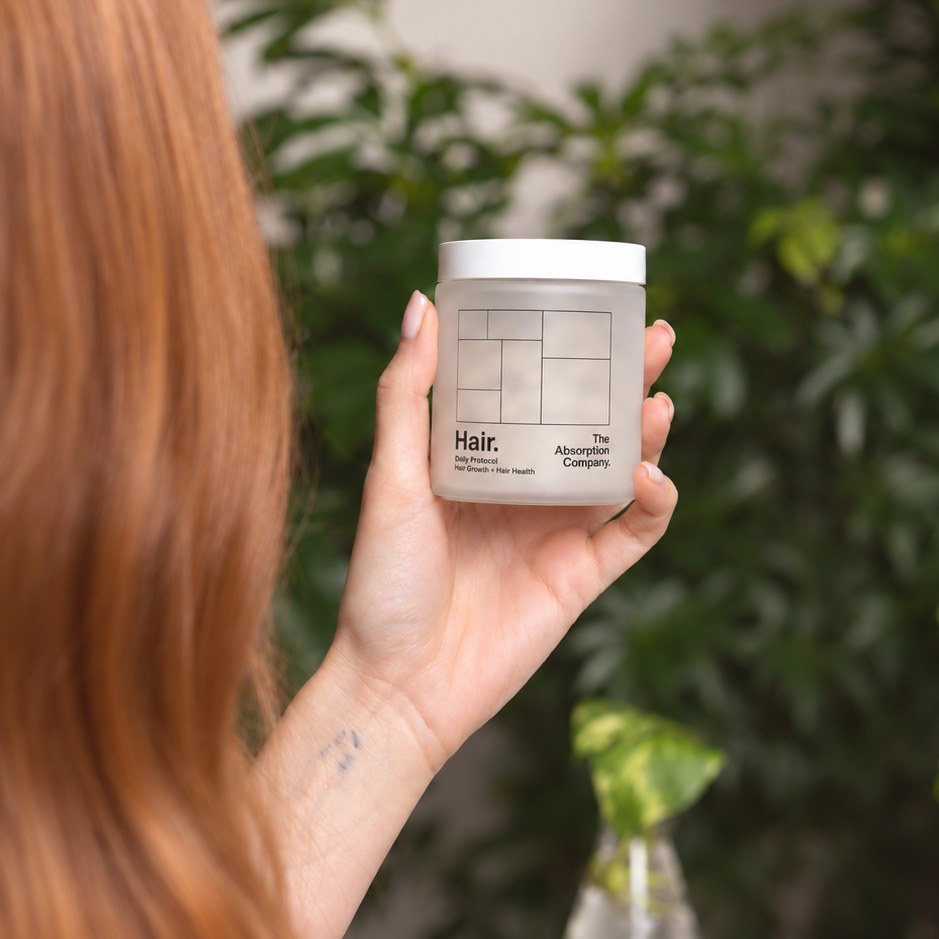 Holding a jar of Hair next to greenery